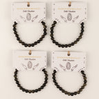 Four Gold Obsidian bracelets on illustrated presentation cards