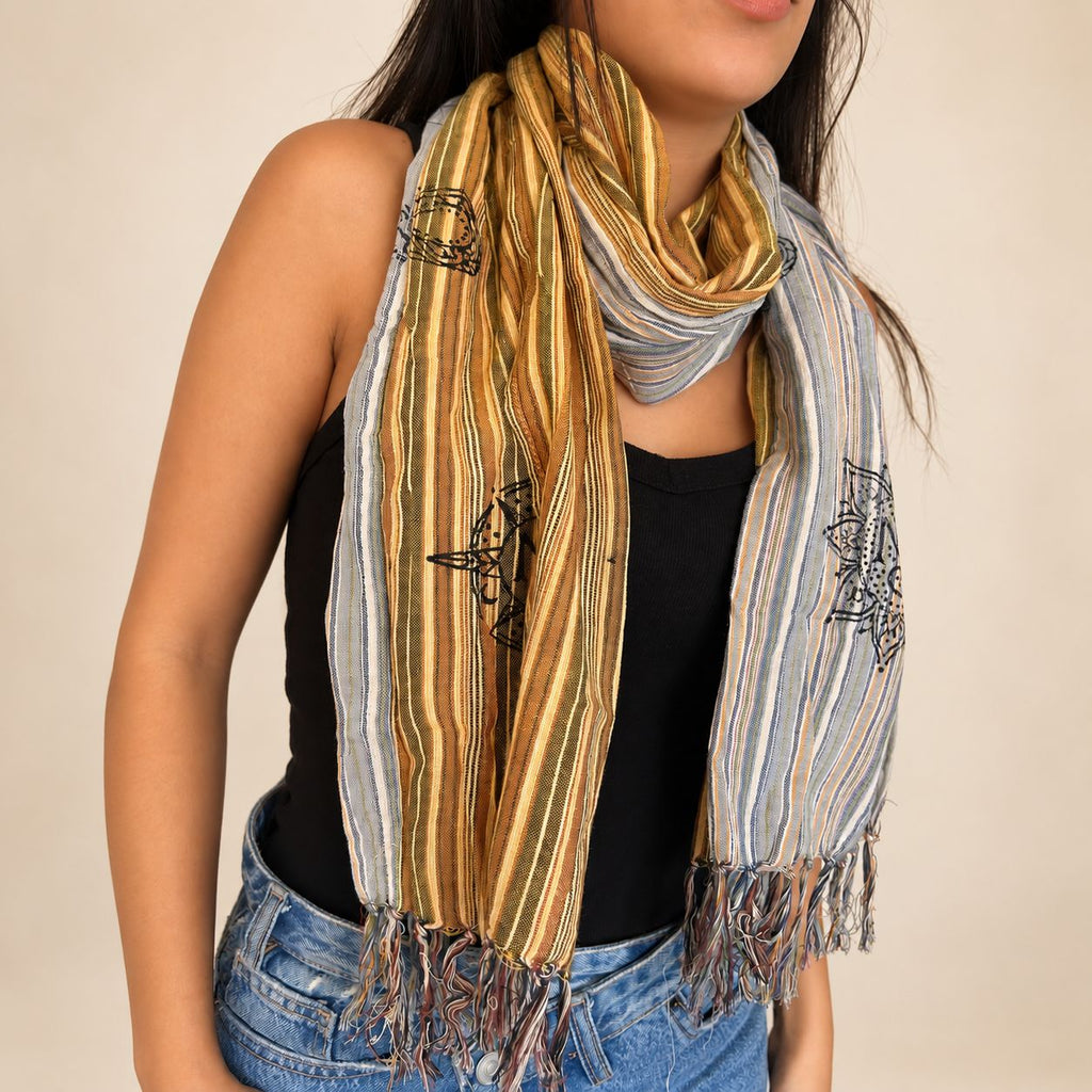 Model wearing the striped Travel Blessing Scarf around her neck