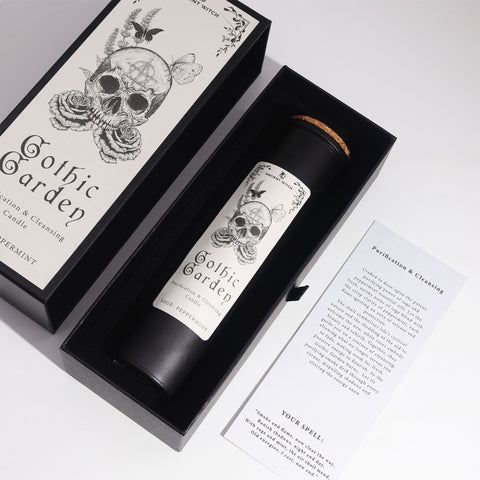 Ancient Witch Gothic Garden candle in its open box with a printed spell card, viewed close