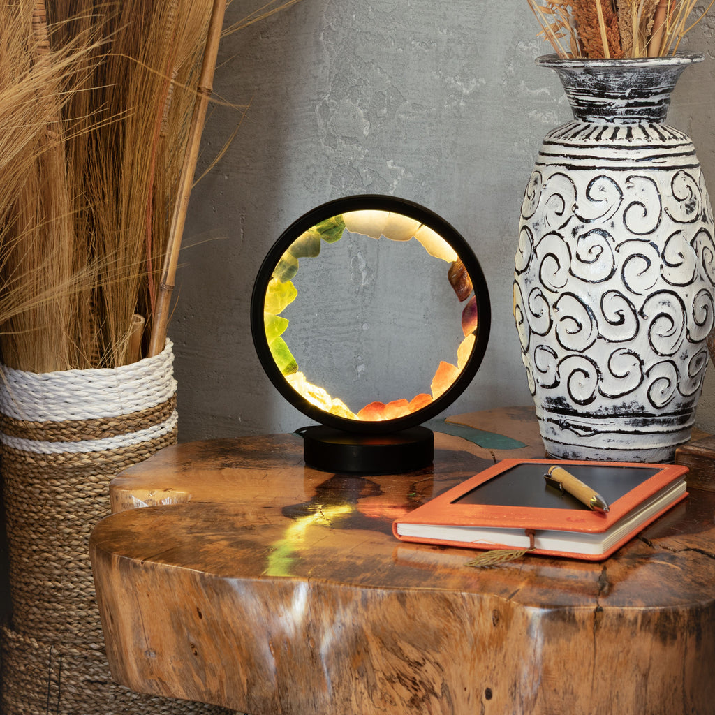 Lit gemstone halo lamp displayed on a wooden table