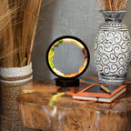 Lit gemstone halo lamp displayed on a wooden table