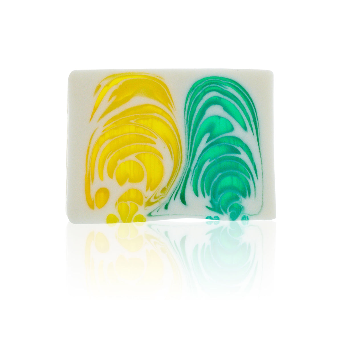 Close-up front view of a white citrus soap slice with yellow and green swirls