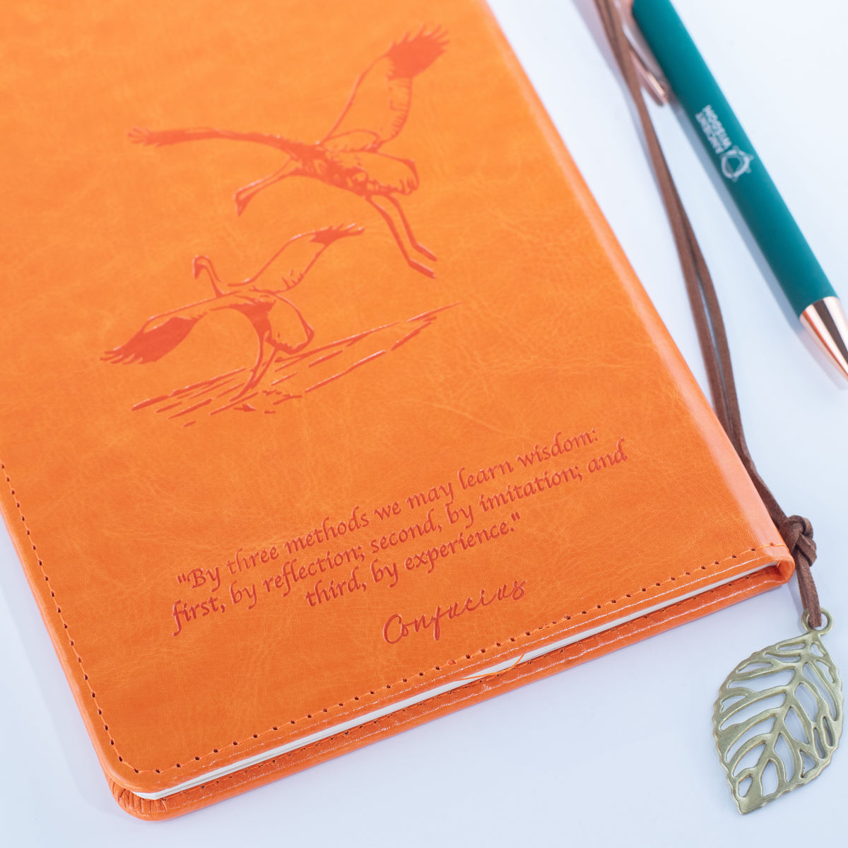 Reverse of the orange notebook with embossed artwork