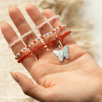 Three bracelets displayed across a hand