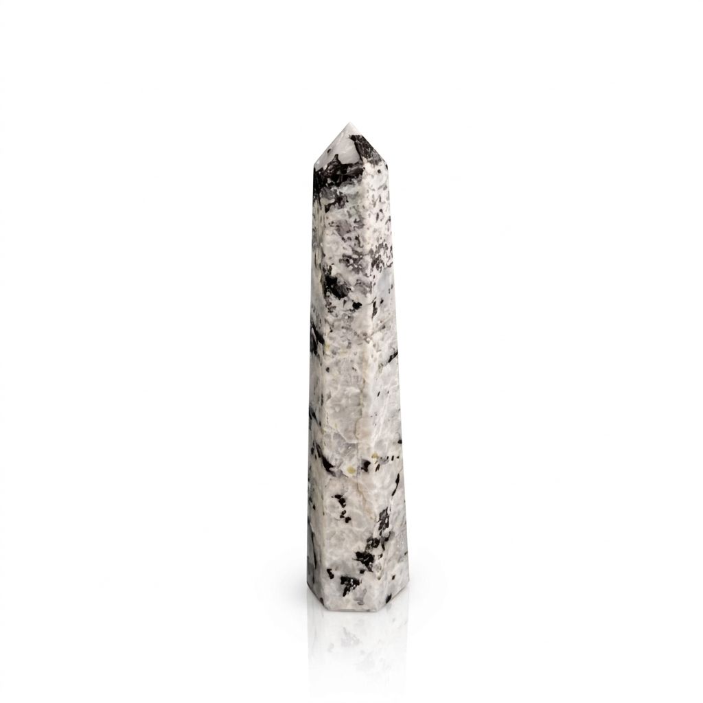 Single white obelisk point with black marbling shown upright against a white background