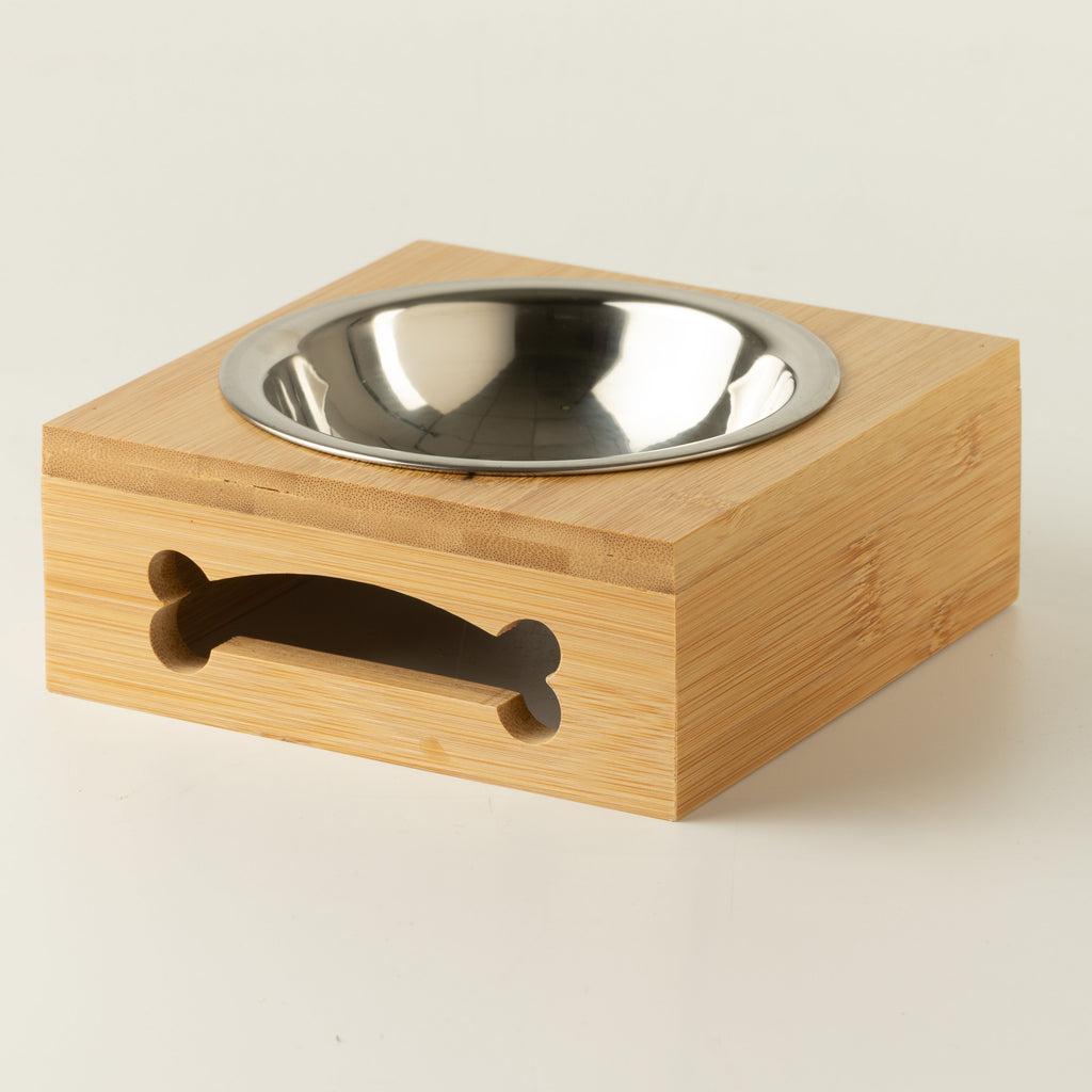 Angled view of the PAW stainless-steel bowl and wooden stand