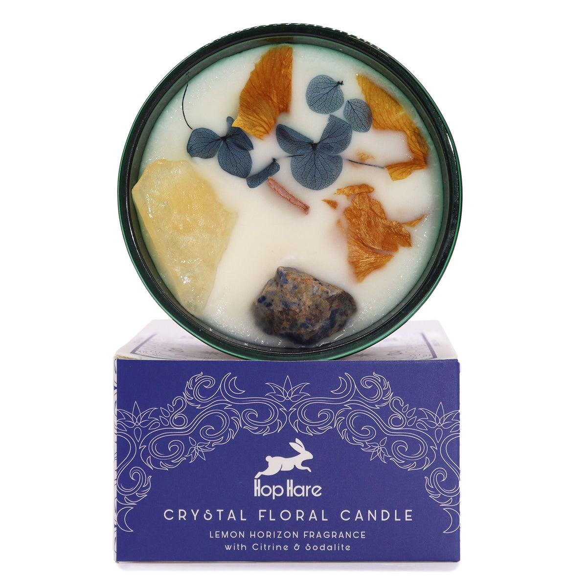 Hop Hare The Sun crystal candle with citrine, sodalite and dried orange flowers, above its blue box