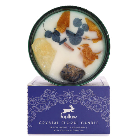 Hop Hare The Sun crystal candle with citrine, sodalite and dried orange flowers, above its blue box