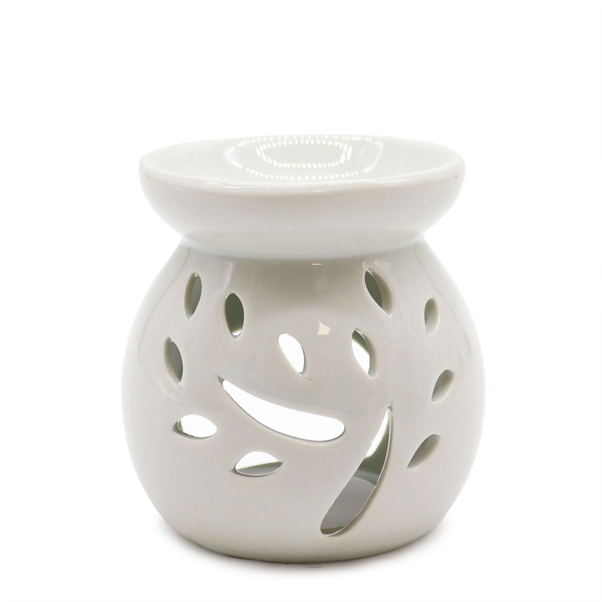White ceramic oil burner with a branch and leaf design cut into the body