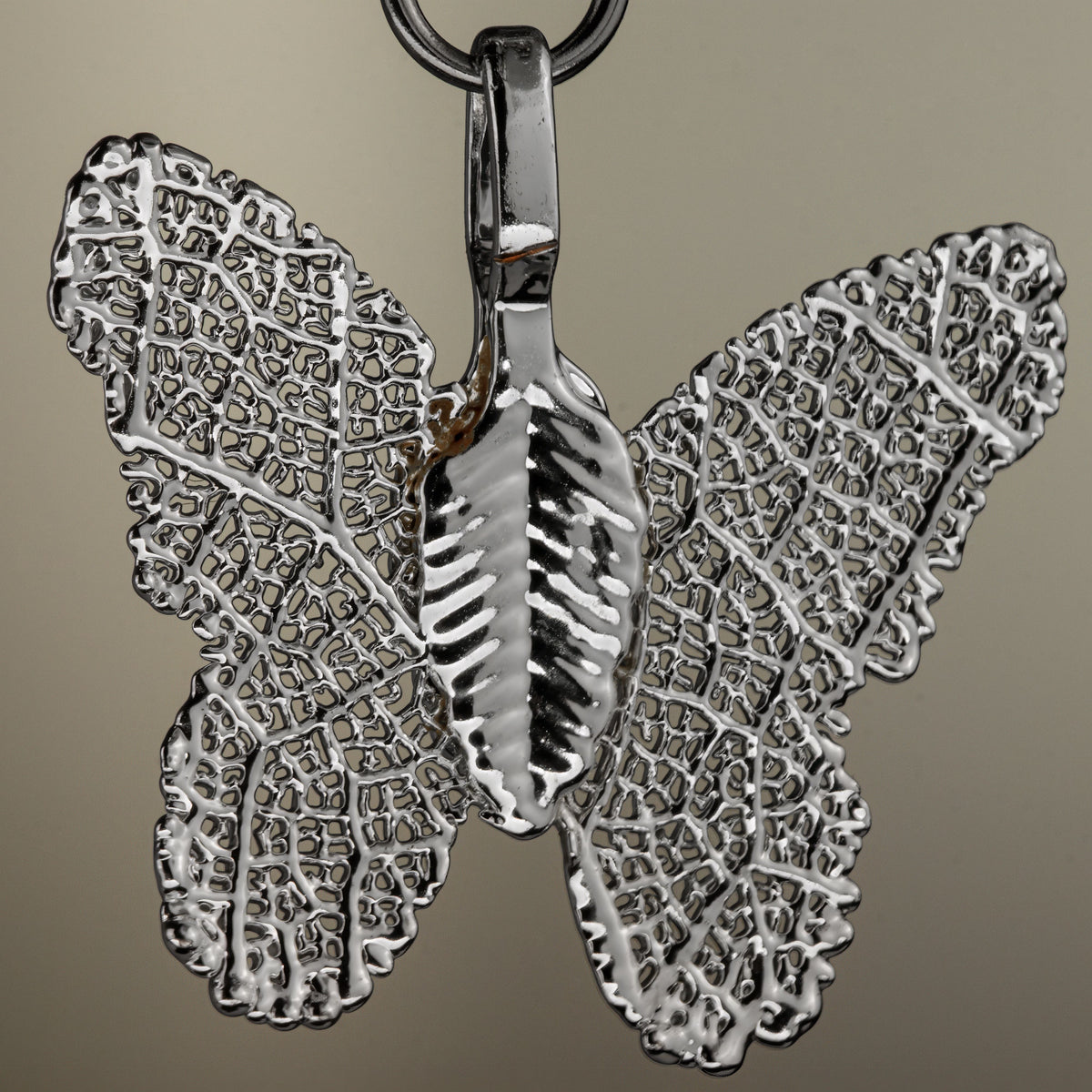 Close-up of the silver-coloured butterfly charm