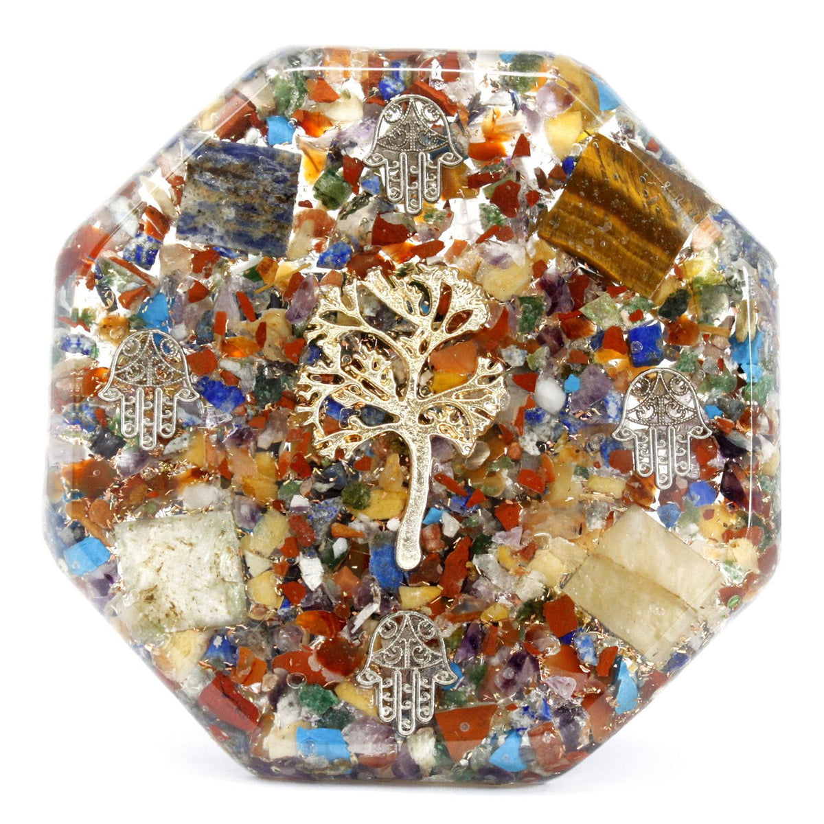 Octagonal orgonite piece with coloured stone chips, a tree of life charm and small hamsa hand charms