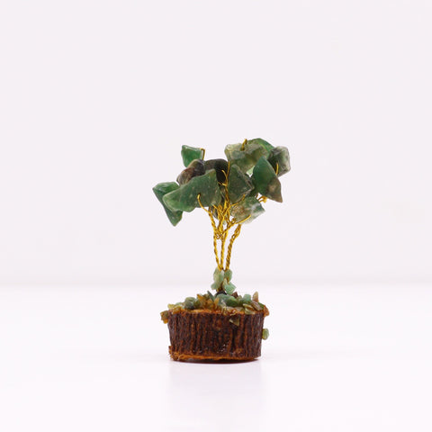 Green gemstone tree shown from the side on a wood base, with its gold wire trunk visible