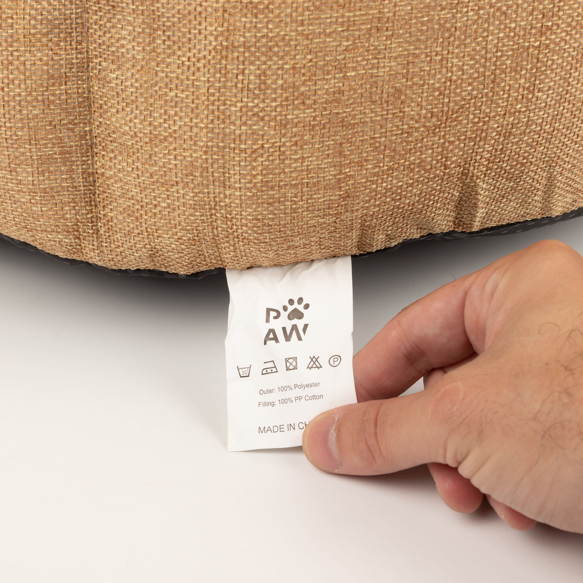 Care label attached to the underside of the pet bed