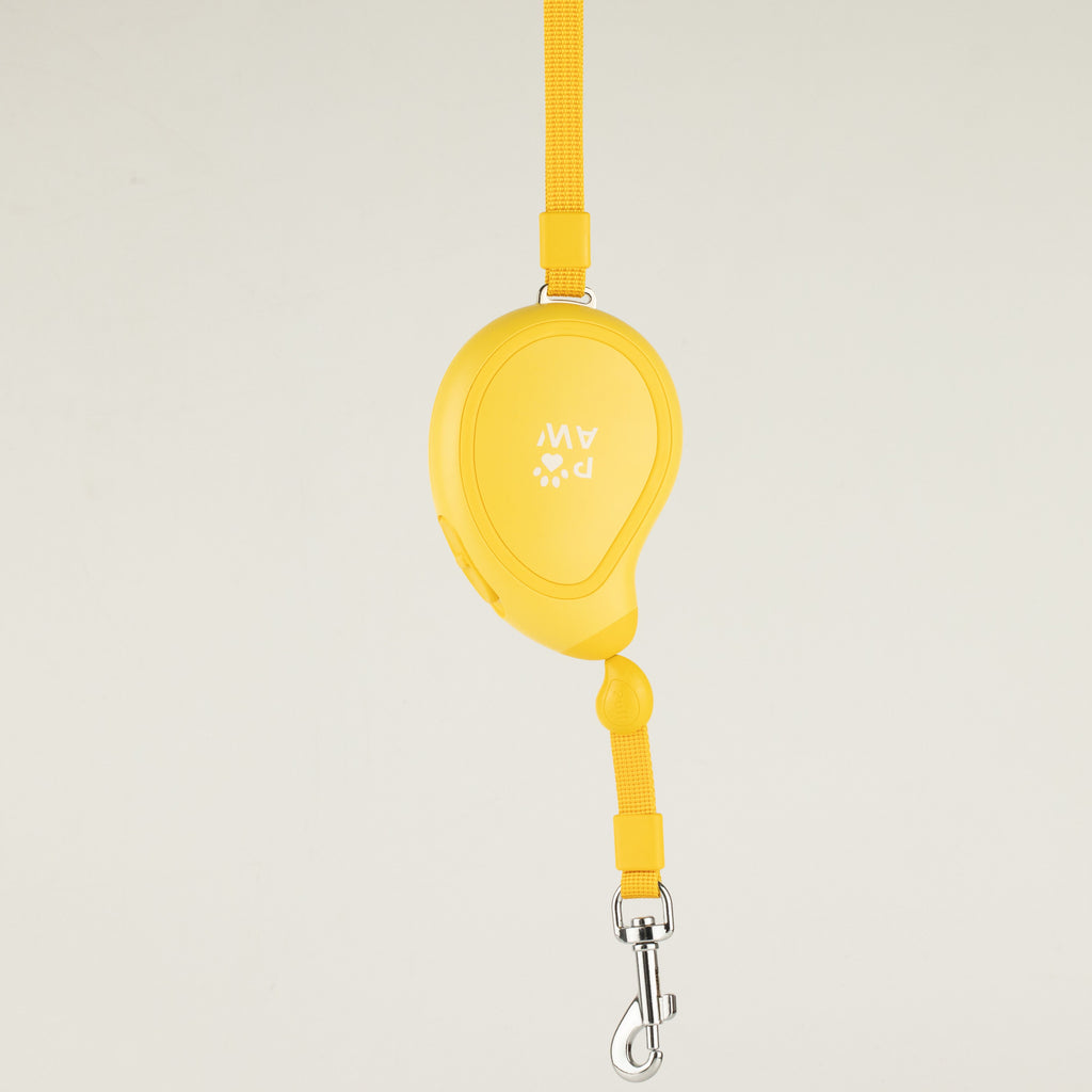 Yellow Paw Mini Mango retractable dog lead, shown hanging with wrist strap and clip