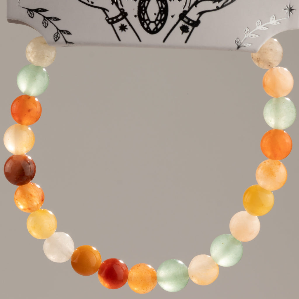 Rainbow Agate bracelet arranged in a loop against its presentation card