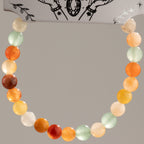 Rainbow Agate bracelet arranged in a loop against its presentation card
