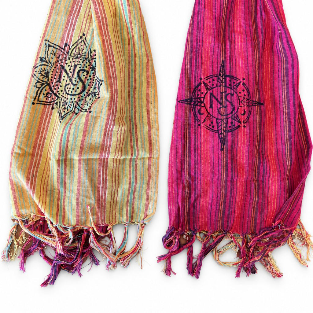 Close-up of the scarf's striped panels, printed symbols and fringed ends