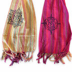 Close-up of the scarf's striped panels, printed symbols and fringed ends
