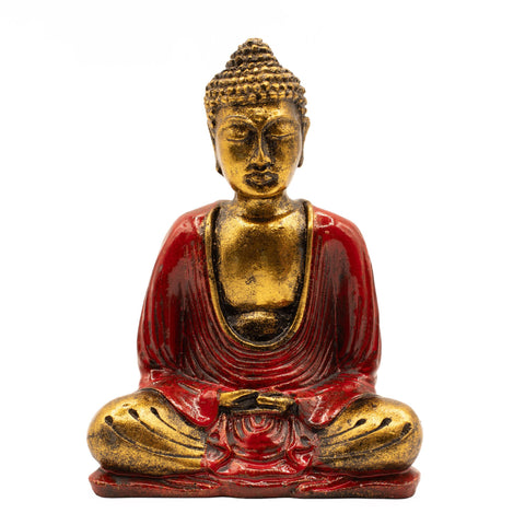 Red and gold Buddha statue seated cross-legged, shown straight on against a plain white background