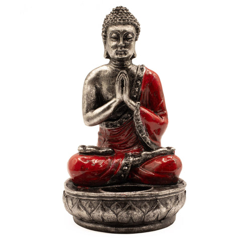 Front view of the red Buddha candle holder against white, showing its hands together and empty dish