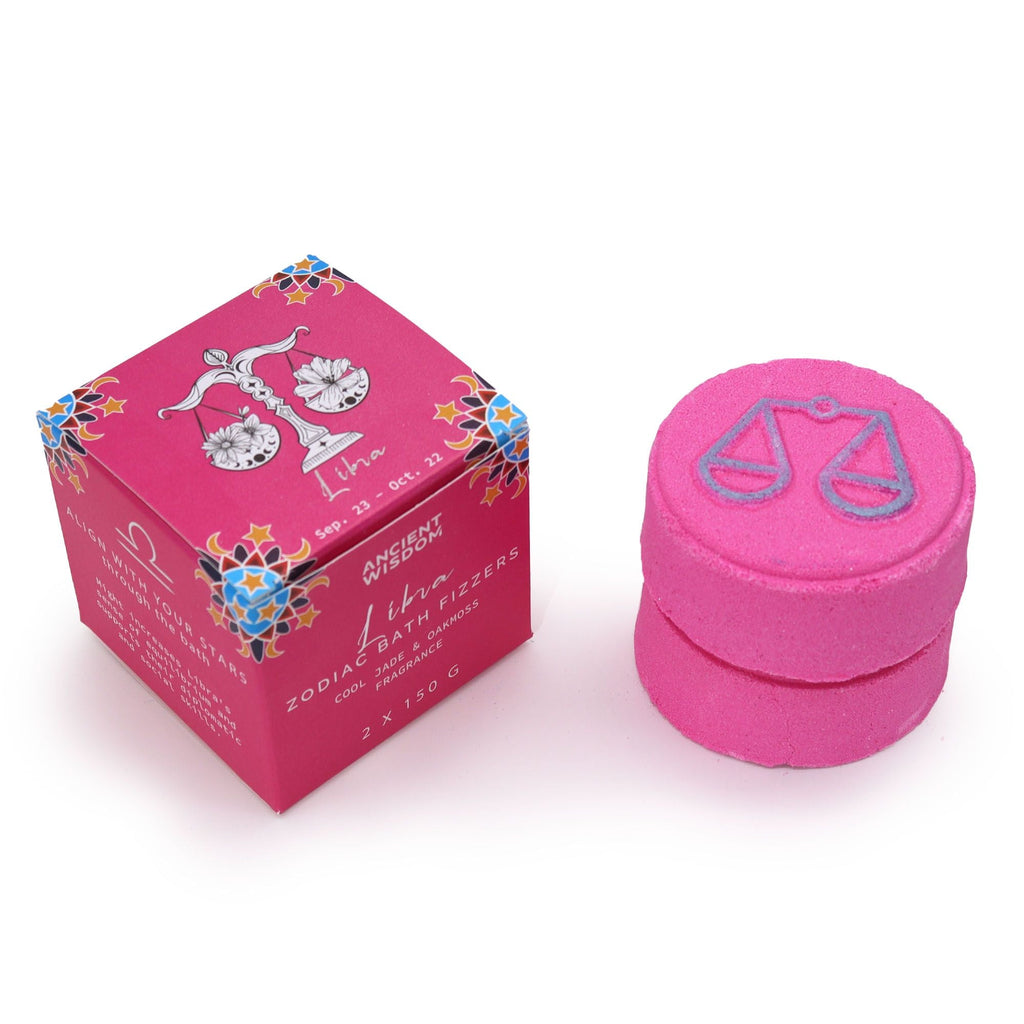 Libra zodiac bath fizzer, pink, next to its magenta gift box with scales artwork