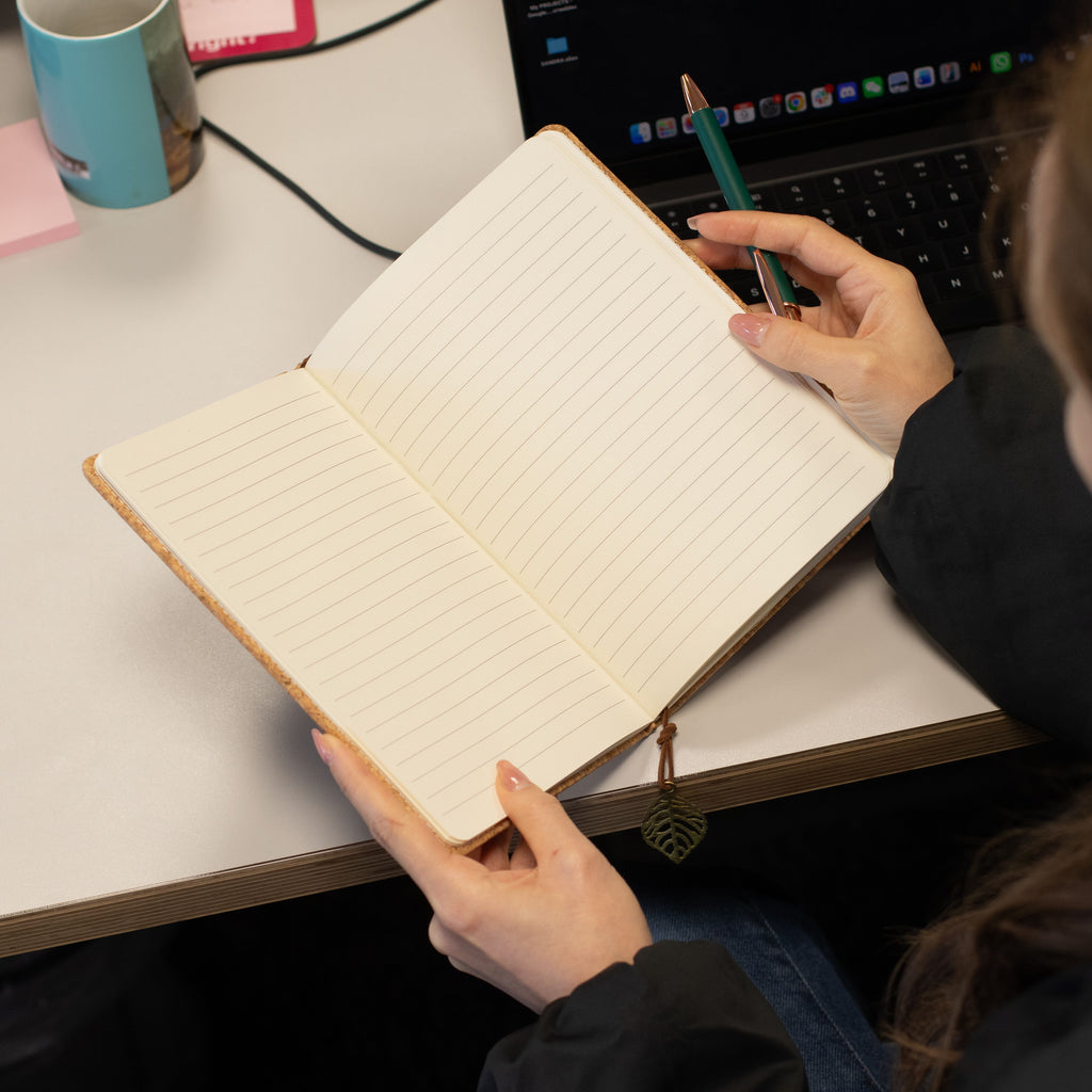 Open lined notebook held open above a desk