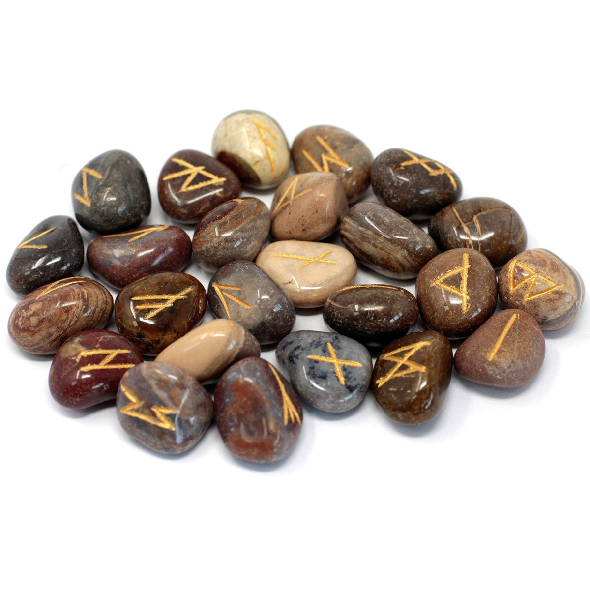 Rune stones arranged together on a white background, showing their varied colours and gold symbols