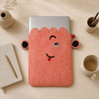 Pink felt pouch shown with a laptop and desk accessories