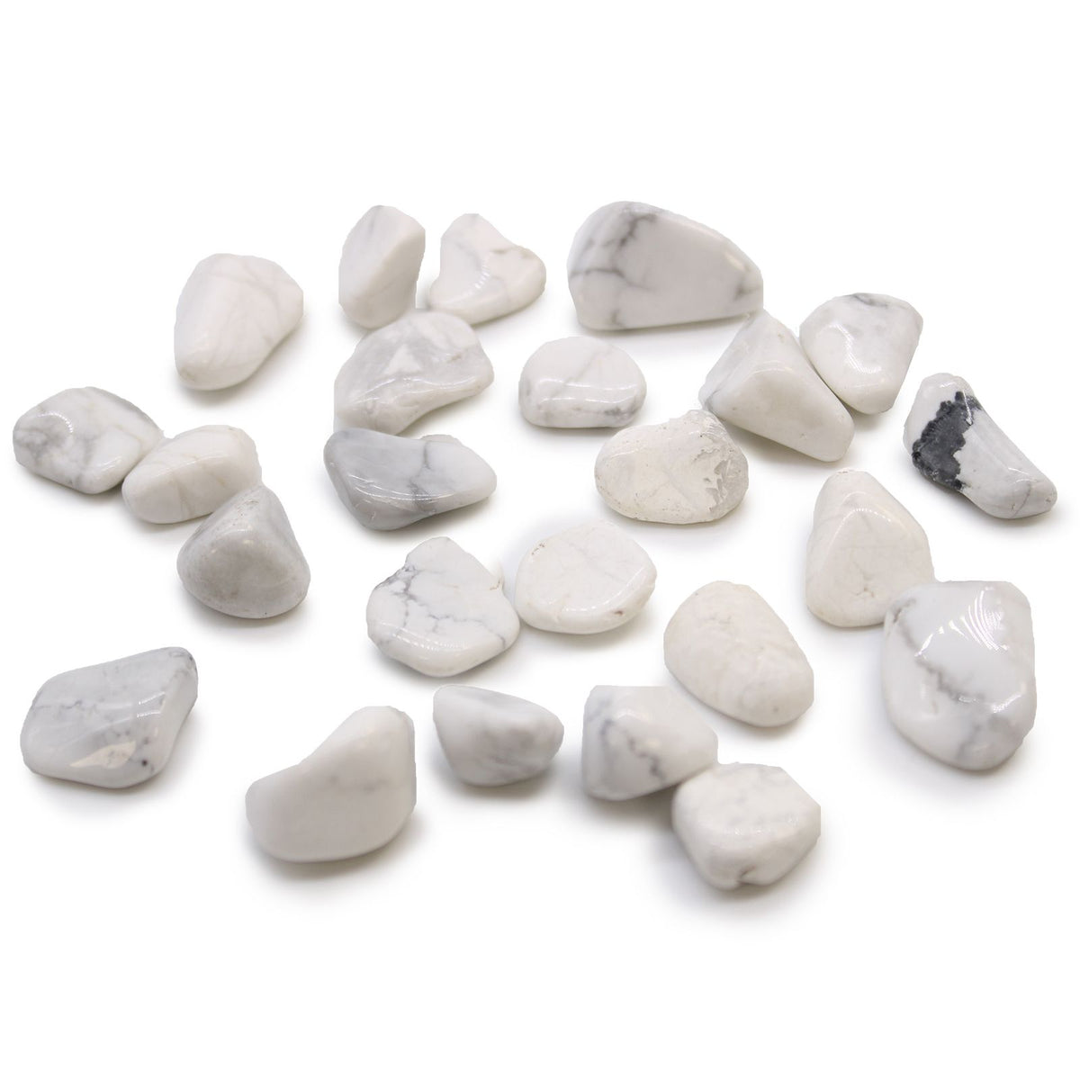Small African Tumble Stones, white polished stones with grey and black veining arranged on a white background