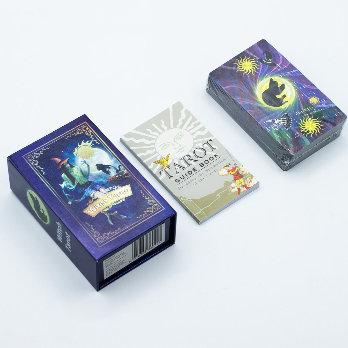 Purple Foil Tarot Card Set, Witch Tarot, with booklet, box, booklet and wrapped cards on a white surface