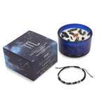 Scorpio zodiac crystal candle, gift box and gemstone bracelet side by side