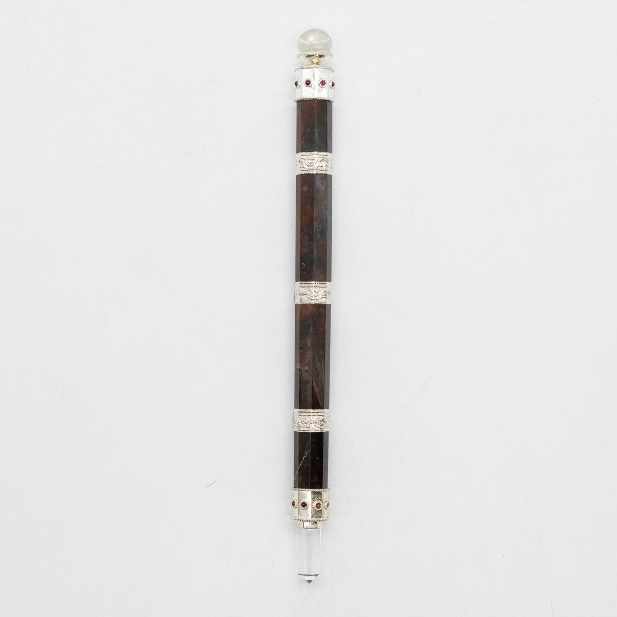 Full wand shown upright against a pale background, with a clear ball top and pointed crystal tip