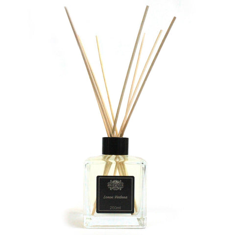 Front view of the clear Lemon Verbena diffuser bottle with pale liquid, black cap and reeds
