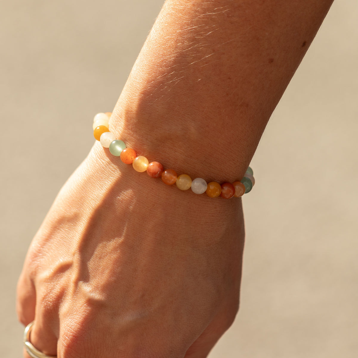 Close view of the Rainbow Agate bracelet on a wrist