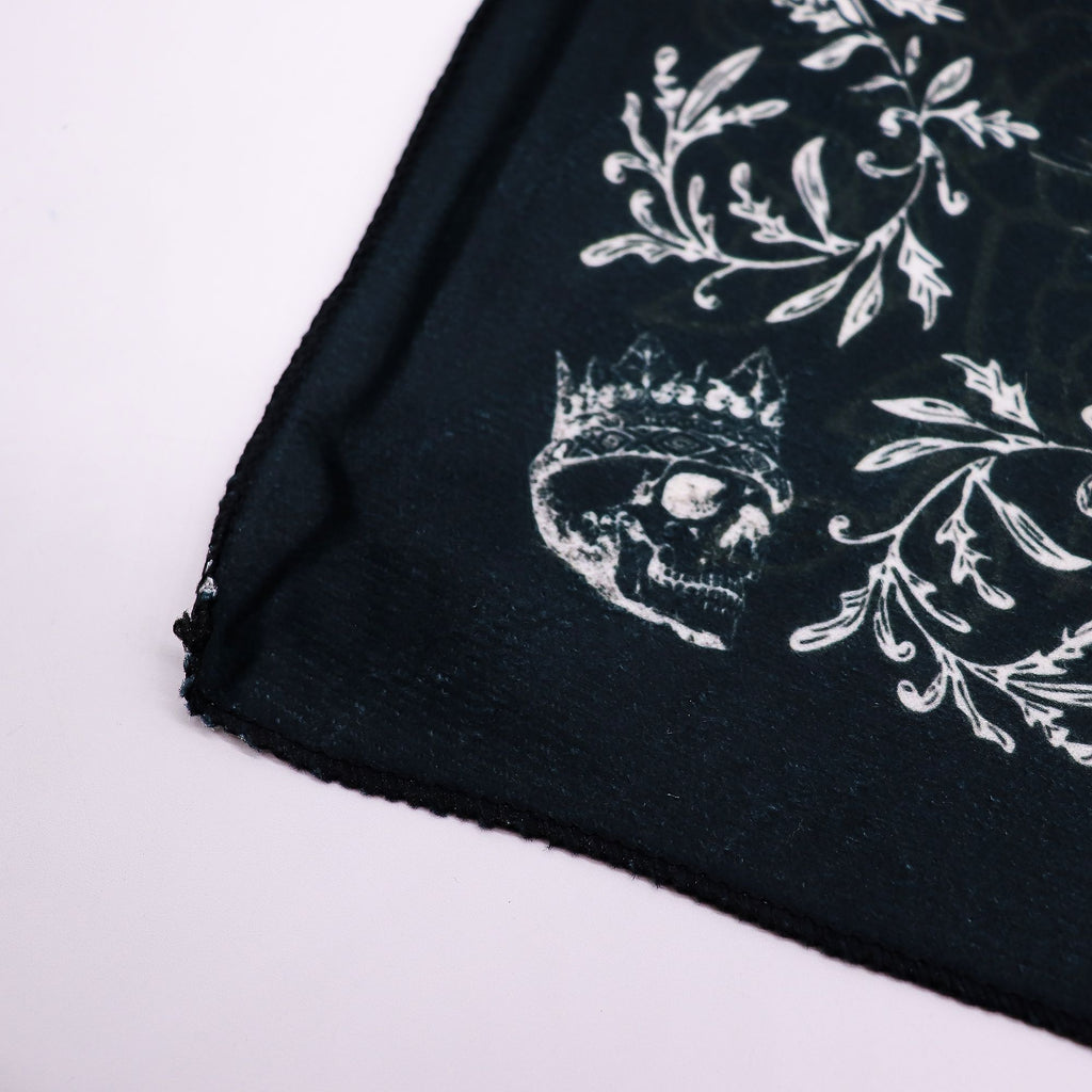 Cloth corner showing a crowned skull and patterned edge