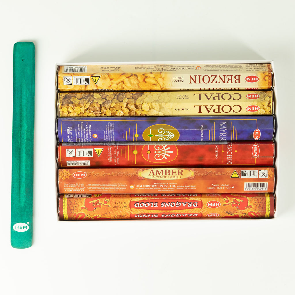 Six HEM incense packs arranged beside the green ashcatcher