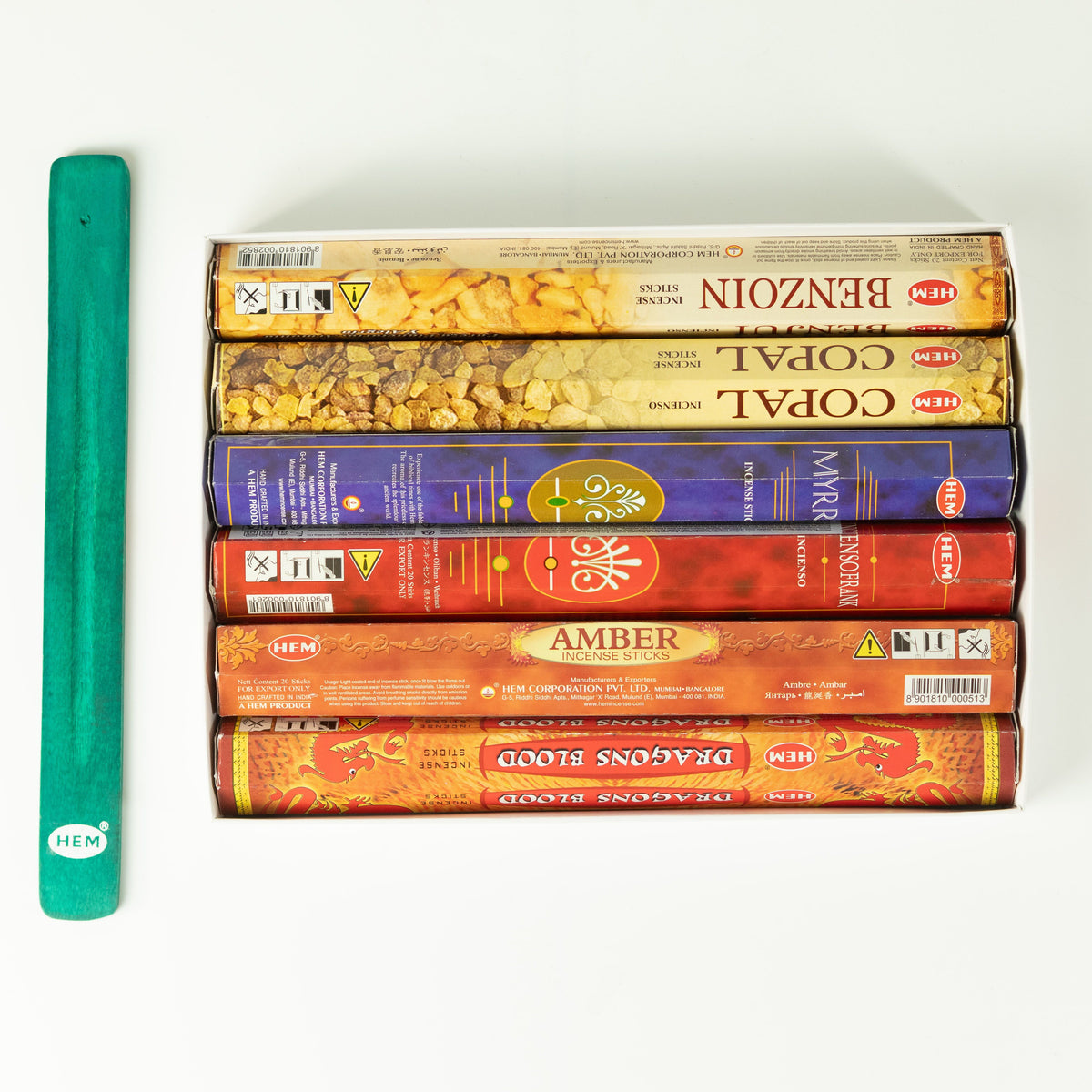 Six HEM incense packs arranged beside the green ashcatcher