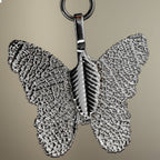 Close-up of the set's silver-coloured butterfly charm