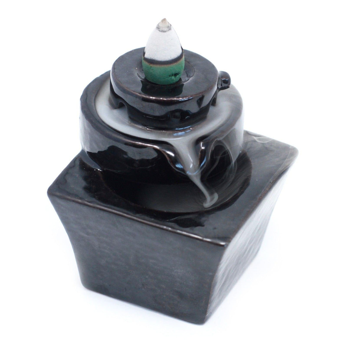 Back Flow Incense Burner, Round to Square, glossy black with an incense cone resting on its round top