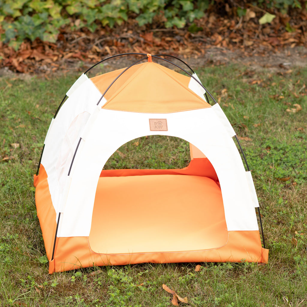 Front view of the empty beige and orange tent bed