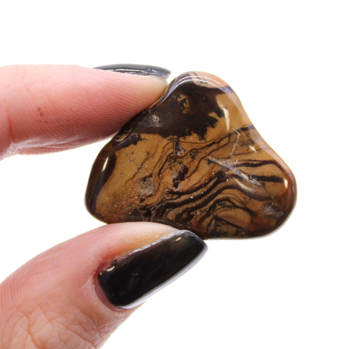 Medium African Tumble Stones, Picture Nguni, one brown and black patterned stone held between fingers