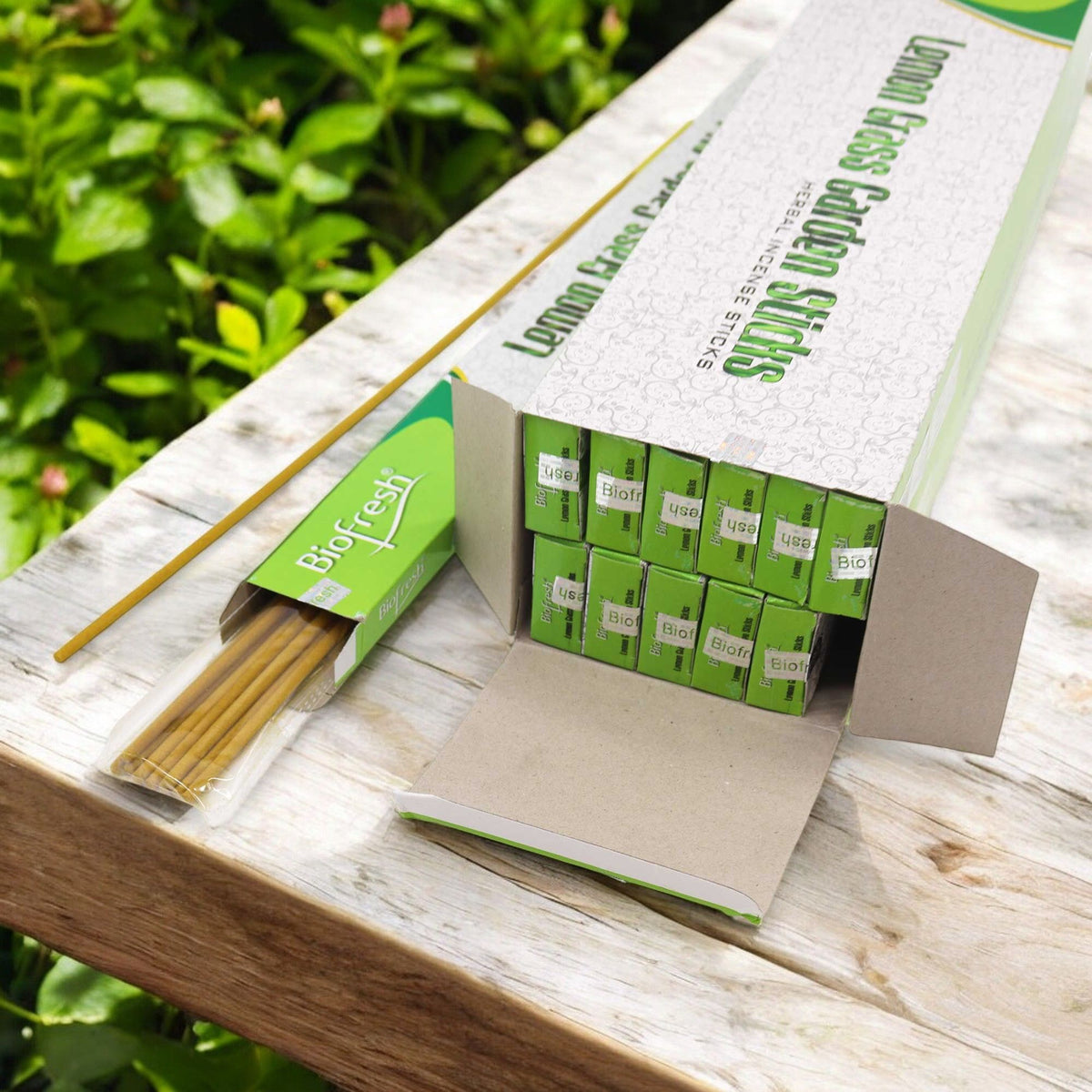 Biofresh Garden Incense Sticks 50cm, Lemongrass in an open box on a wooden garden table, with sticks in a clear sleeve