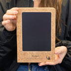 Notebook held up to show its screen and cover