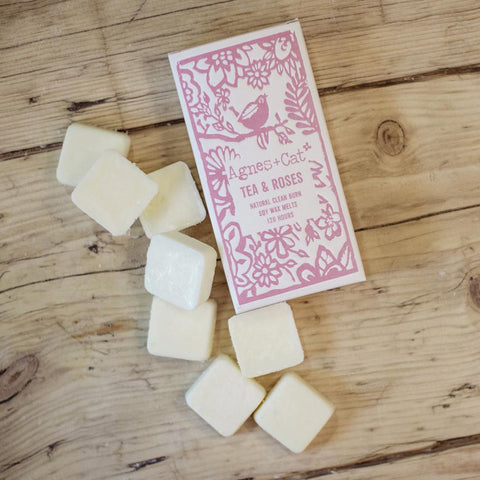 Agnes + Cat Box of 8 Wax Melts, Tea + Roses, pink box and pale wax cubes on a wooden surface