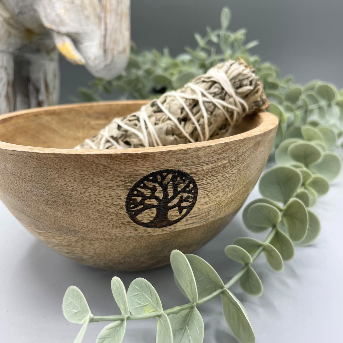 Wooden Smudge and Ritual Offerings Bowl, Tree of Life, with a wrapped bundle and greenery, close-up