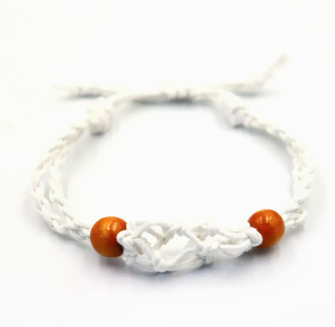 White gemstone bracelet cord viewed from the front, with two brown beads and a knotted centre on white