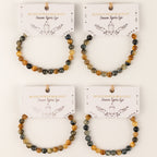 Four Dream Tigereye bracelets on illustrated cards