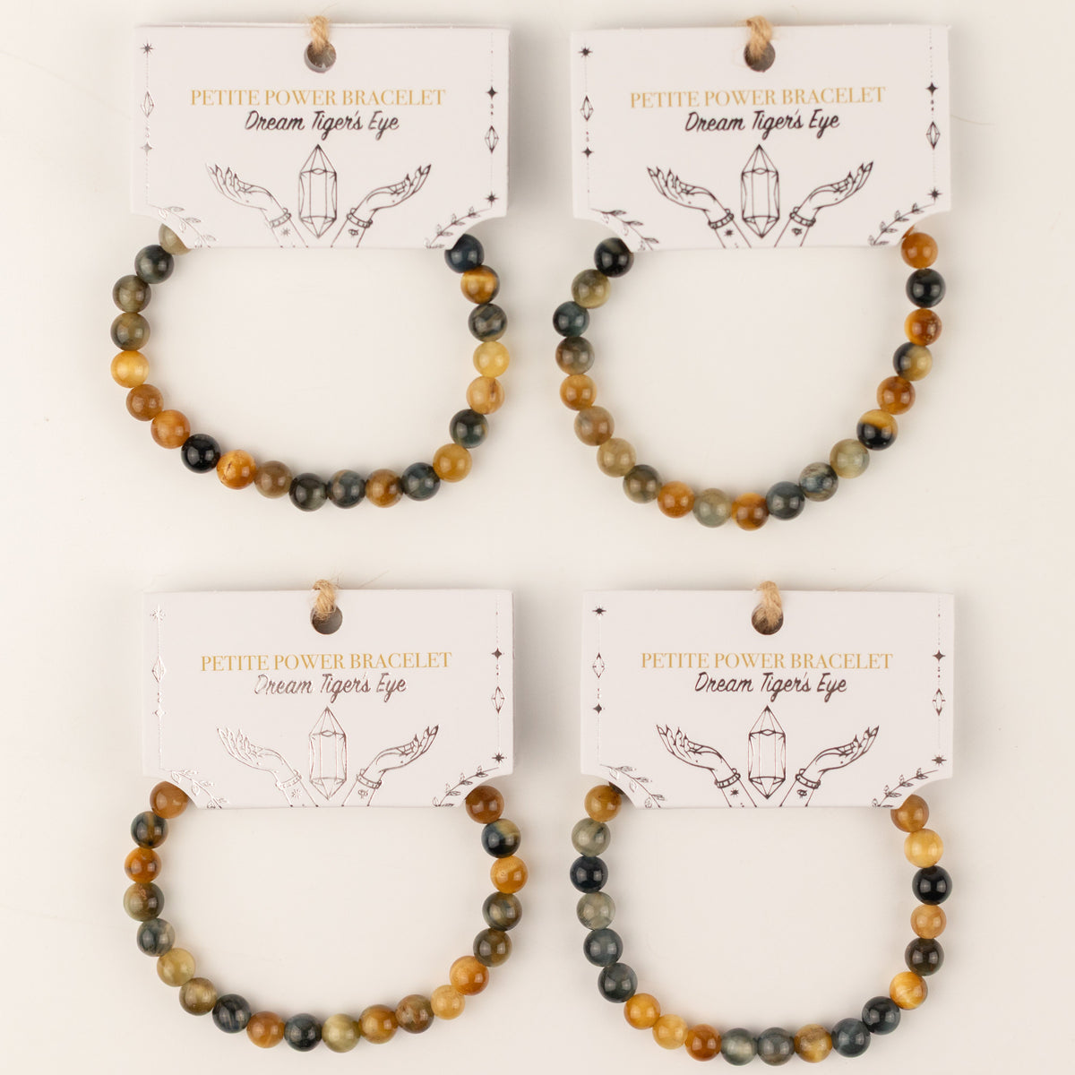 Four Dream Tigereye bracelets on illustrated cards