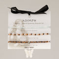 Nymph Spirit Sea Sunset bracelets on an illustrated card