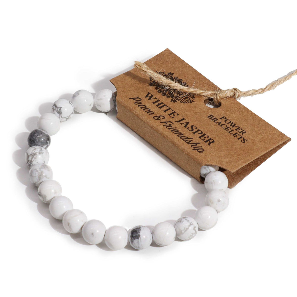 White Jasper bracelet angled beside its kraft tag on a white background